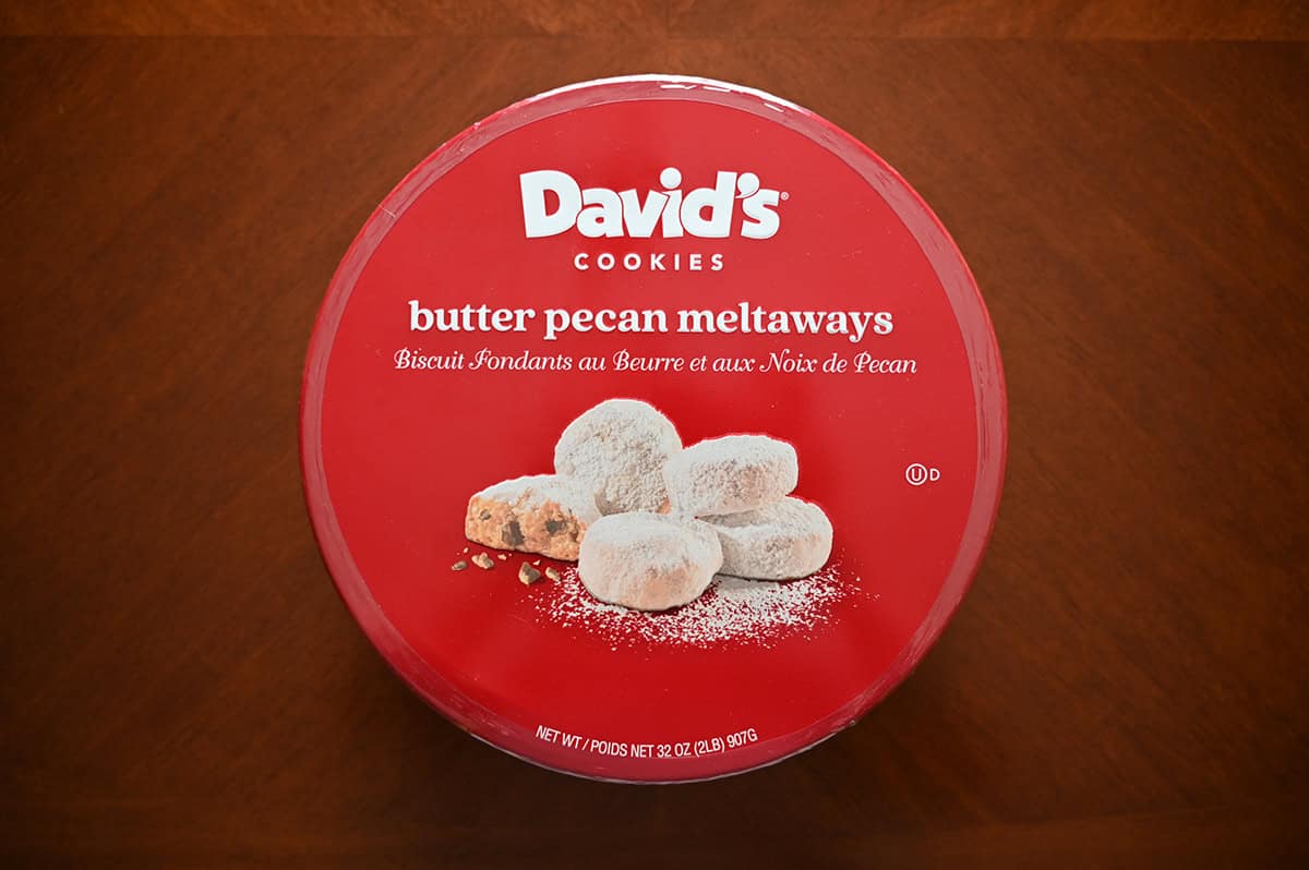 Image of the Costco David's Butter Pecan Meltaways cookie tin sitting on a table unopened. 