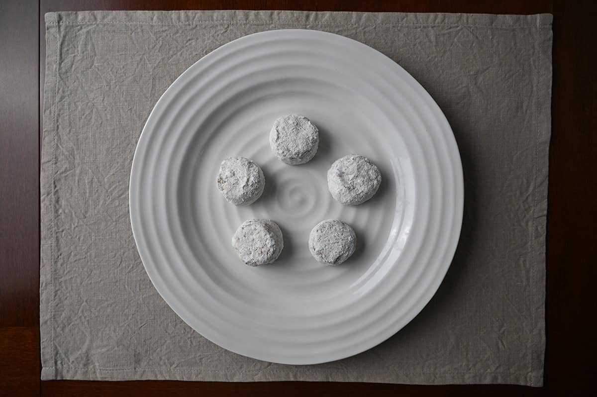 Image of five pecan meltaway cookies served on a white plate.