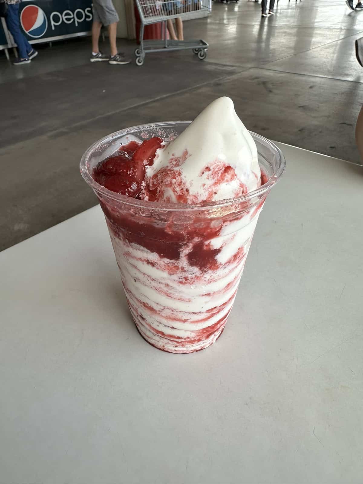 Image of a vanilla sundae with strawberry sauce from the Costco food court.