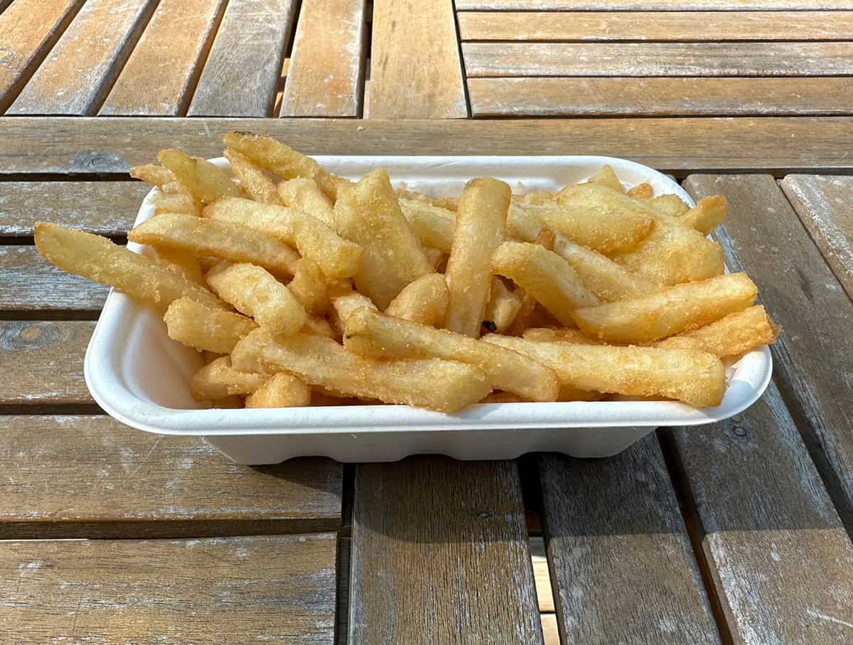 Top down side view image of a container of fries from the Costco food court.