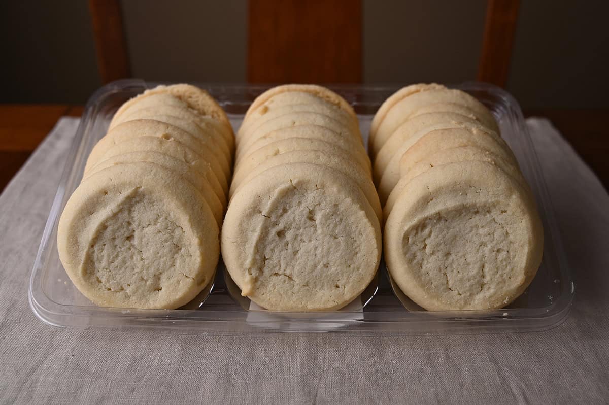 Image of 24 Costco butter shortbread cookies sitting in a plastic container with the lid off.