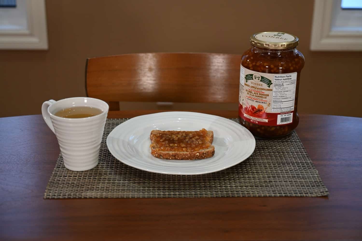 Another photo of the jar of tea base alongside the toast covered in the tea base and the tea made from the tea base.