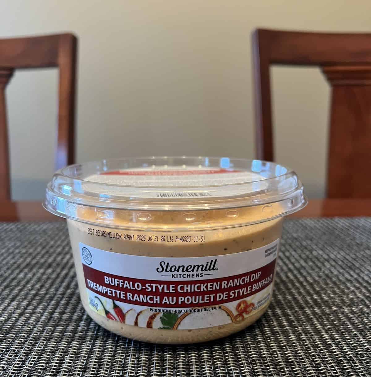 Image of the Stonemill Kitchens Buffalo-Style Chicken Ranch Dip container sitting on a table unopened.