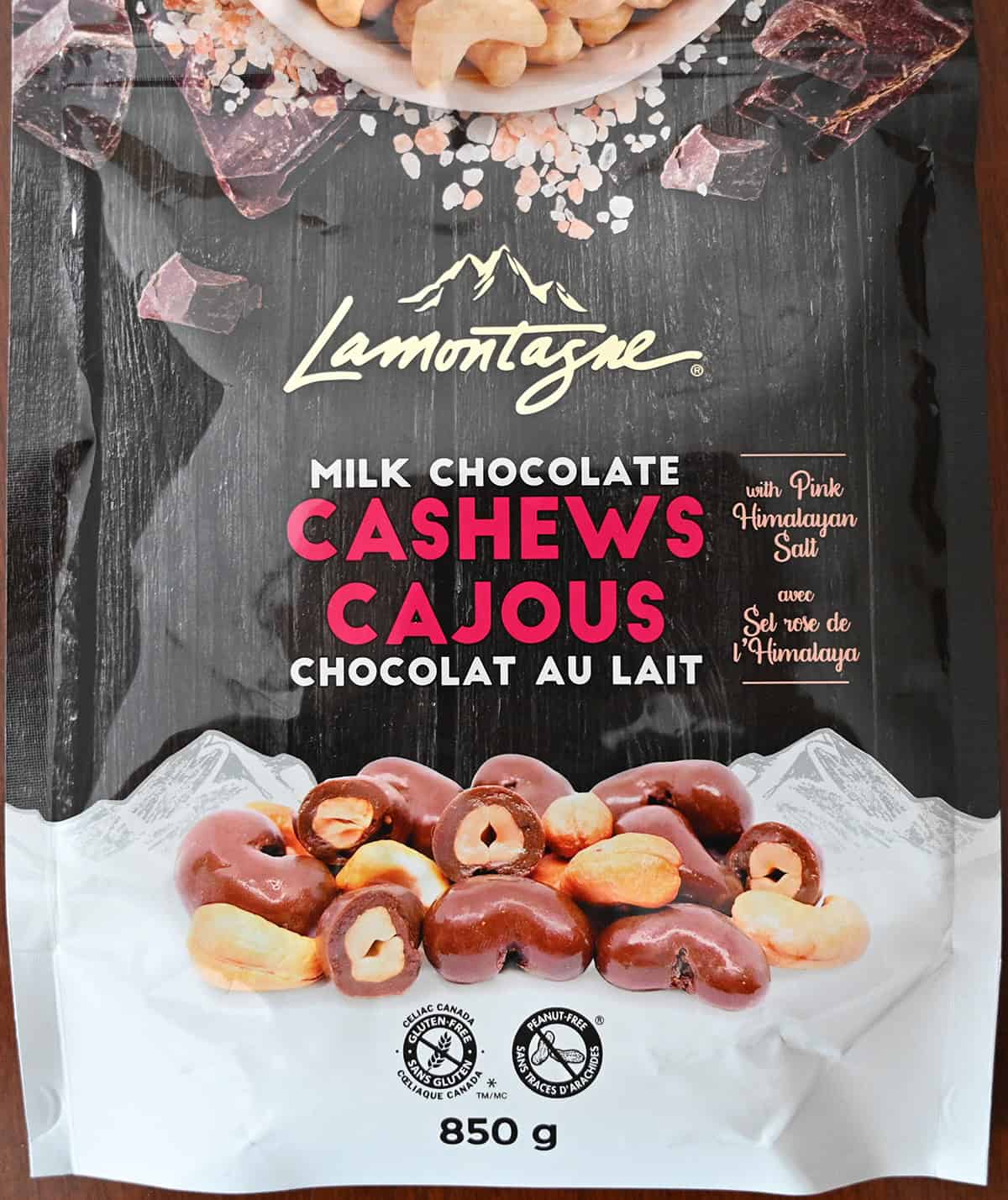 Closeup image of the front of the bag of milk chocolate cashews showing the size of the bag and that they're gluten-free and peanut-free.