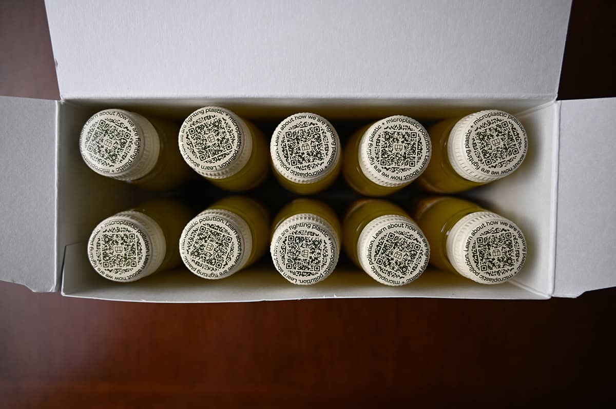 Top down image of an open box of ginger defence showing 10 small unopened bottles in the box.