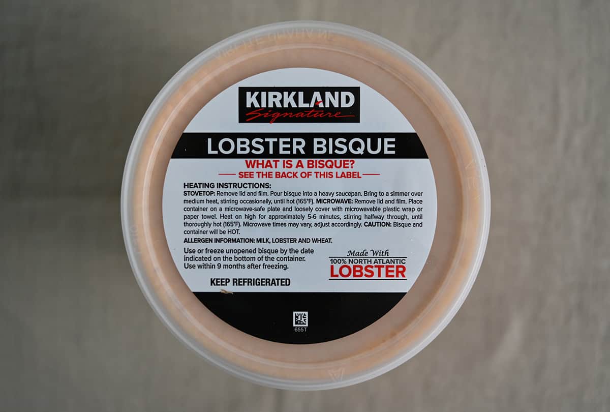 Top down image of the lobster bisque lid showing that it says it needs to be kept refrigerated and the heating instructions.