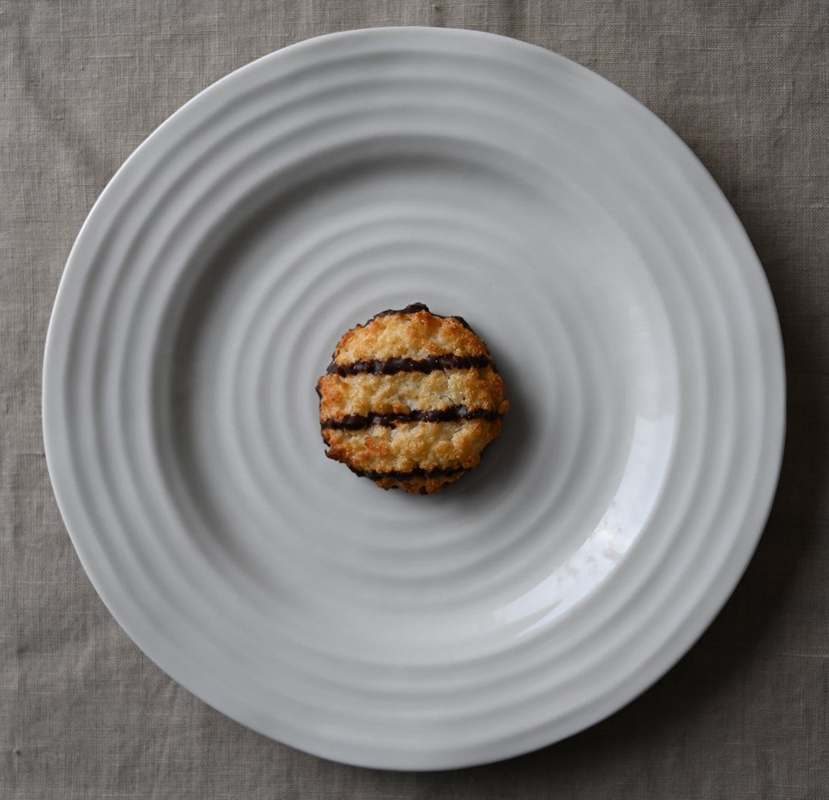 Top down image of one Poppie's cookie served on a white plate. 
