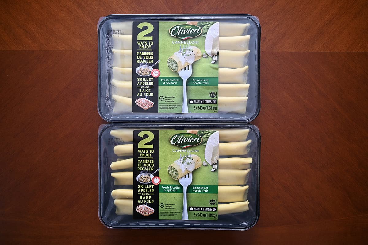 Top down image of two unopen packs of cannelloni sitting on a table.