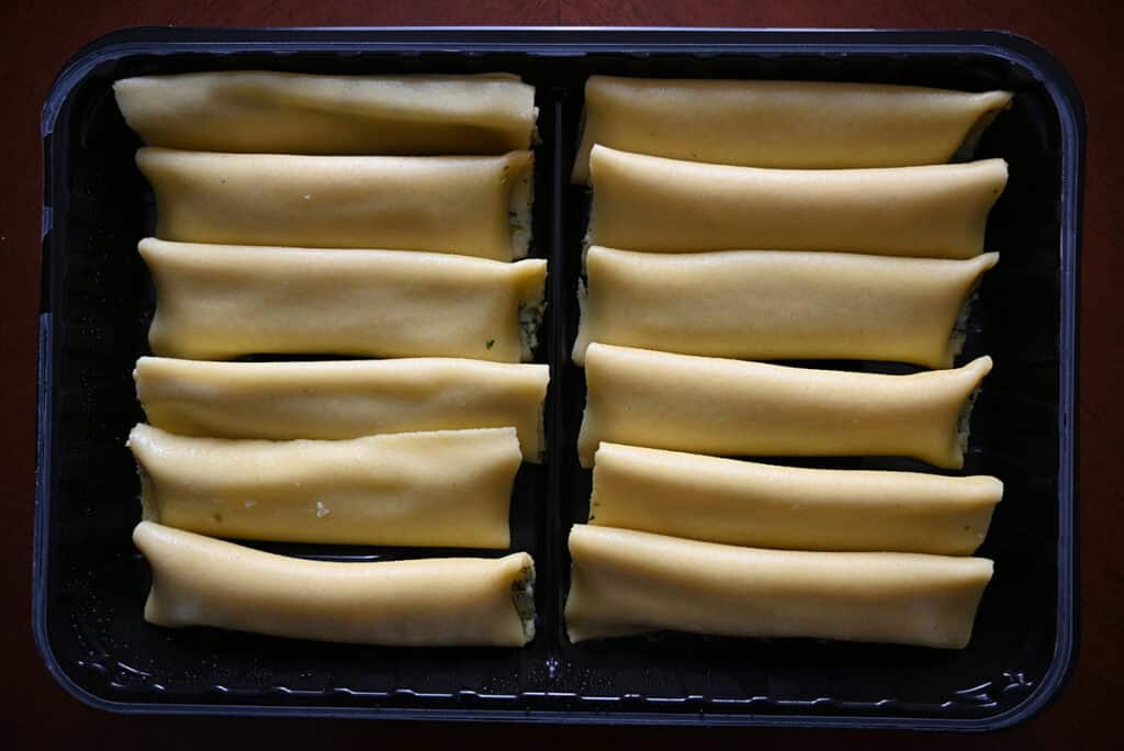 Top down image of an open pack of uncooked cannelloni.