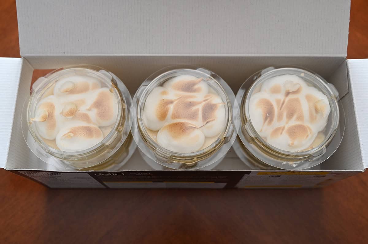 Top down image showing the box of pies open showing three sealed ramekins sitting on the box.
