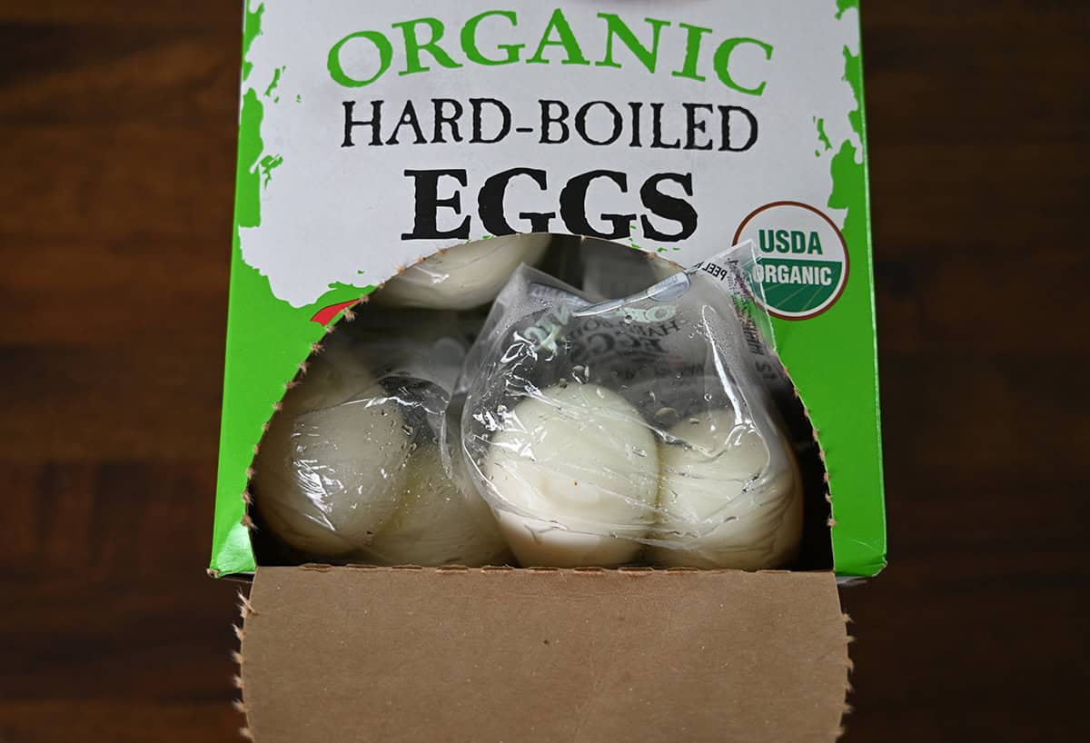Image of an open box of packaged hard boiled eggs sitting on a table. 