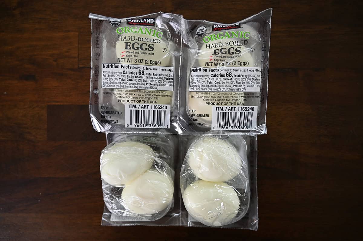 Top down image of four packs of hard boiled eggs sitting on a counter.
