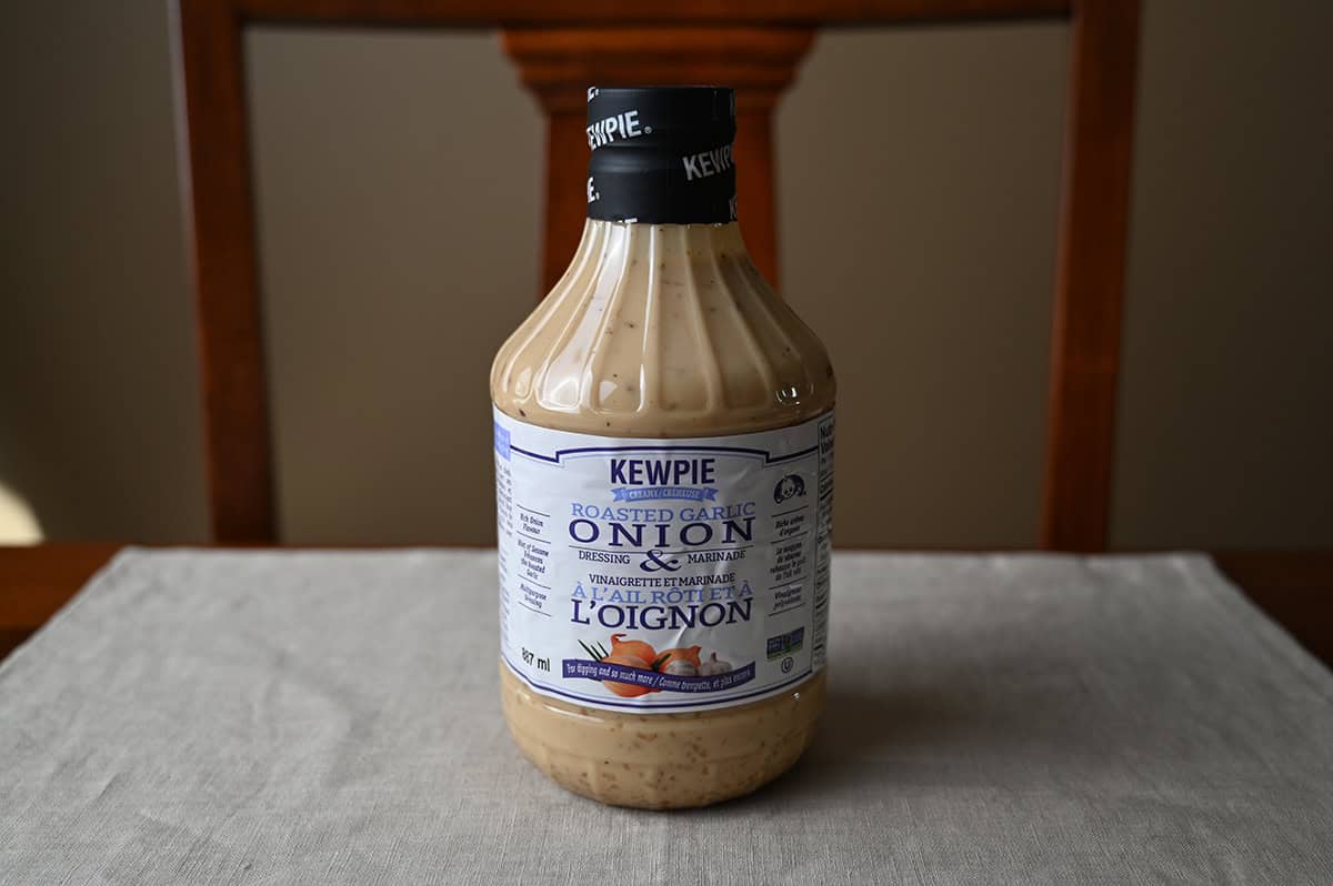 Image of the Costco Kewpie Roasted Garlic Onion Dressing & Marinade bottle unopened sitting on a table.