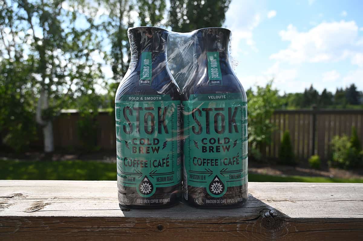 Image of two bottles of cold brew unopened and packaged together sitting on a deck outside.