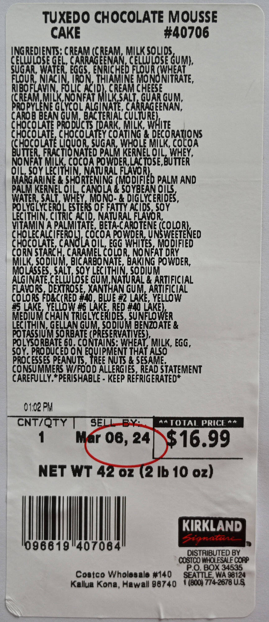 Closeup image of the label from the cake packaging showing best before date, cost and ingredients.