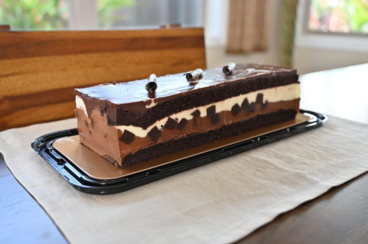 Sideview closeup image of the entire cake sitting on a table so you can see all the layers in the cake.