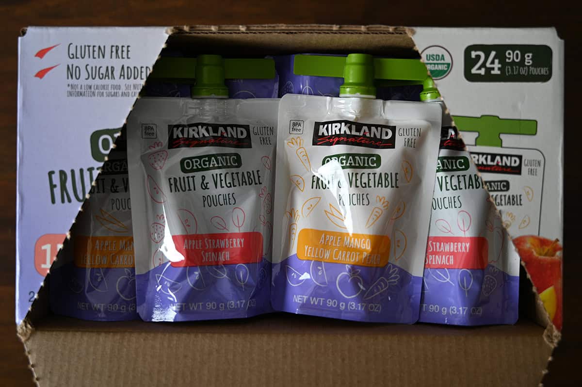 Image of an open box of Kirkland Signature Organic Fruit & Vegetable Pouches showing what the unopened pouches look like.