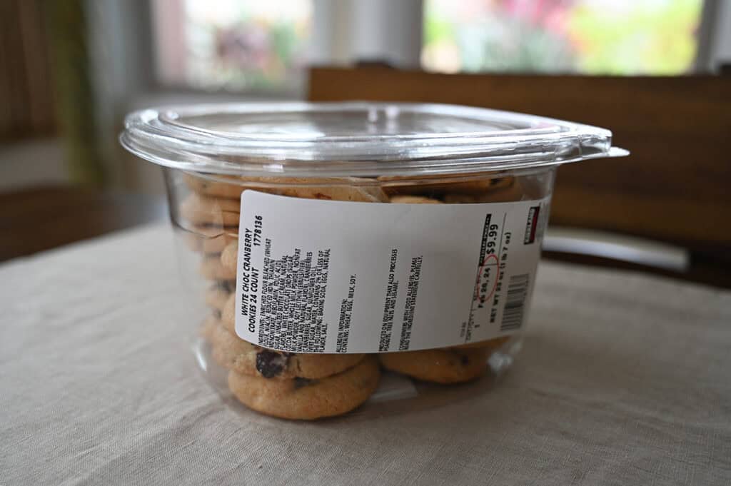 Image of an unopened container of the Costco Kirkland Signature White Chocolate Cranberry Cookies sitting on a table. 