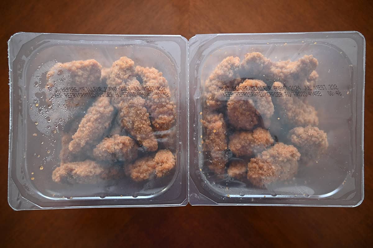 Top down image of two unopened plastic packages of tenders sitting on a table. 