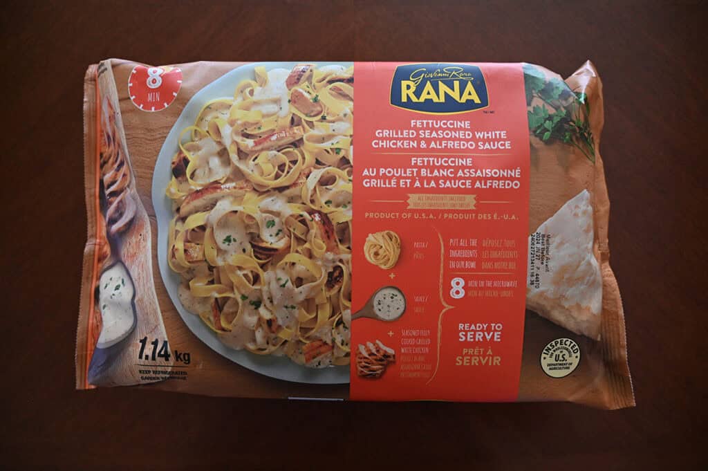 Image of the Costco Rana Fettucine Grilled Seasoned White Chicken & Alfredo Sauce unopened in the packaging sitting on a table.