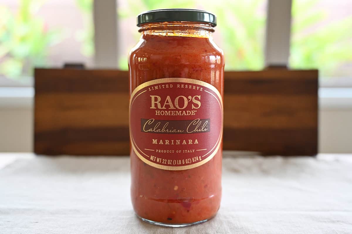 Image of one Costco Rao's Homemade Calabrian Chili Marinara jar sitting on a table unopened.