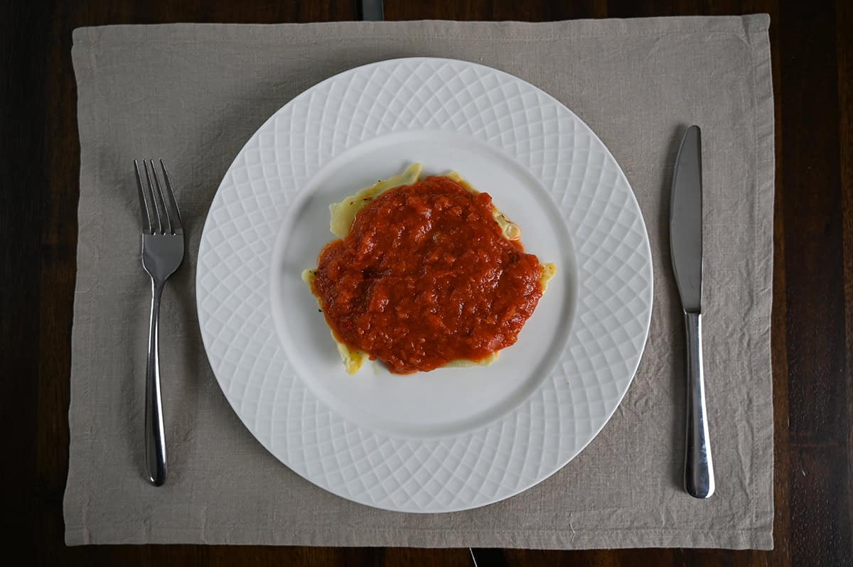 Top down image of a plate of pasta with tomato sauce on it.