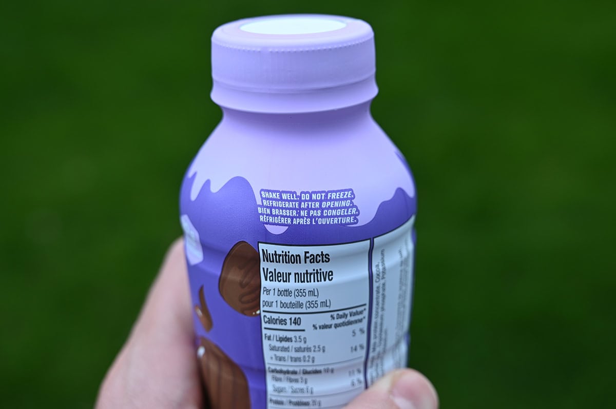 Closeup image of a protein shake bottle showing serving instructions.