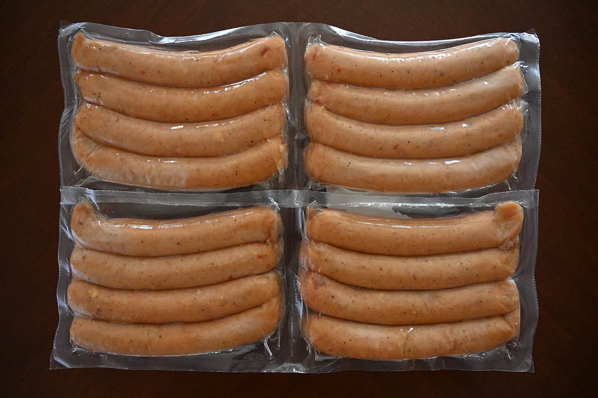 Top down image of four packs of sausages vacuum sealed sitting on a table unopened.