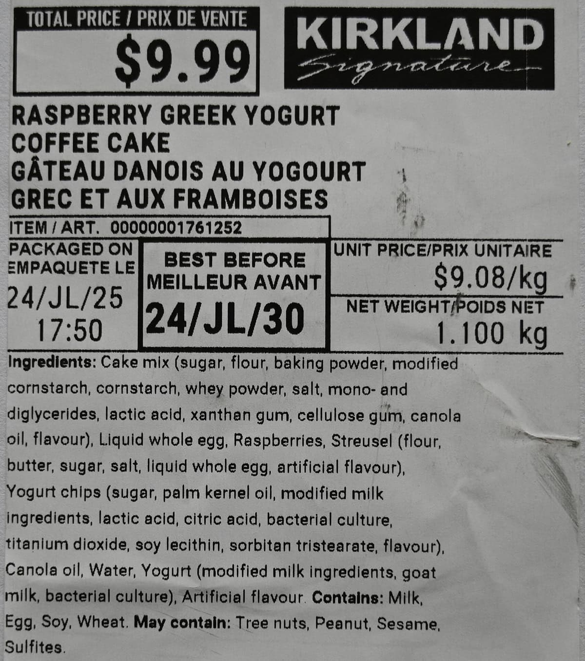 Closeup image of the label from the coffee cake showing the best before date, cost and ingredients.