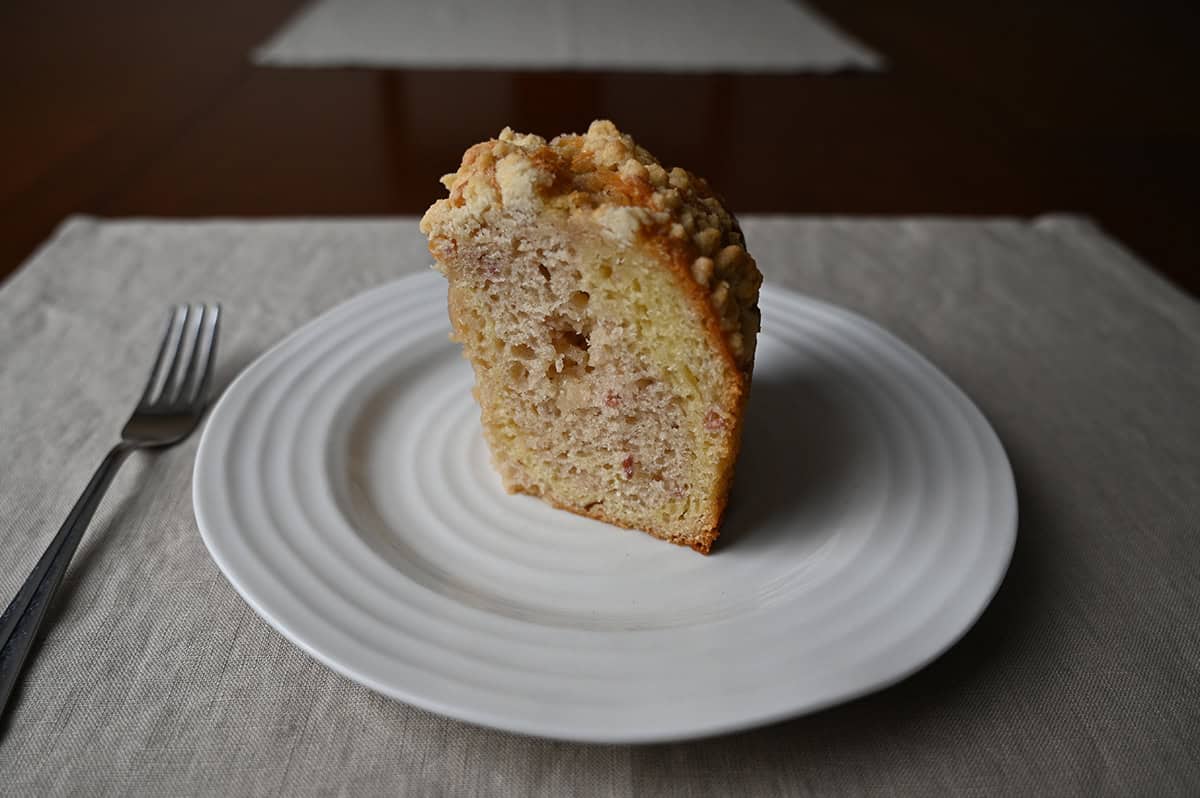 Image of one slice of coffee cake served on a white plate.