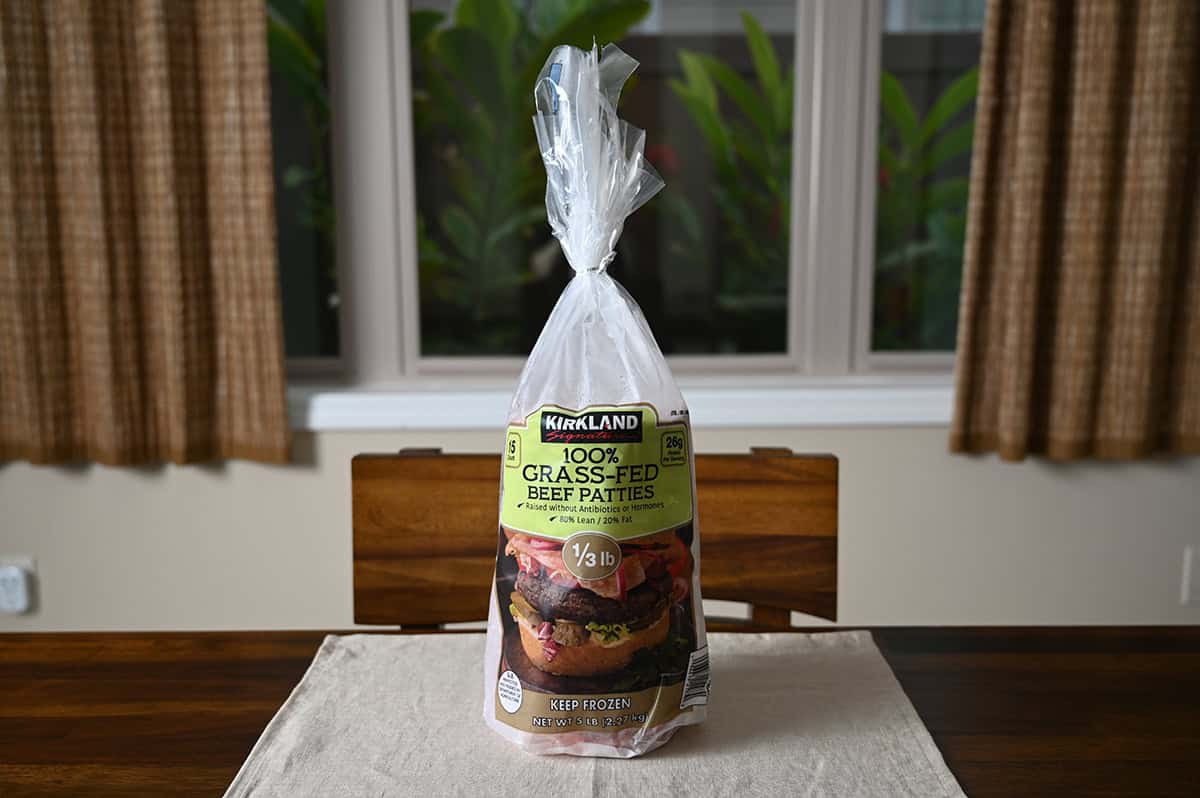 Image of a bag of Kirkland Signature Grass-Fed Beef Patties sitting on a table unopened.