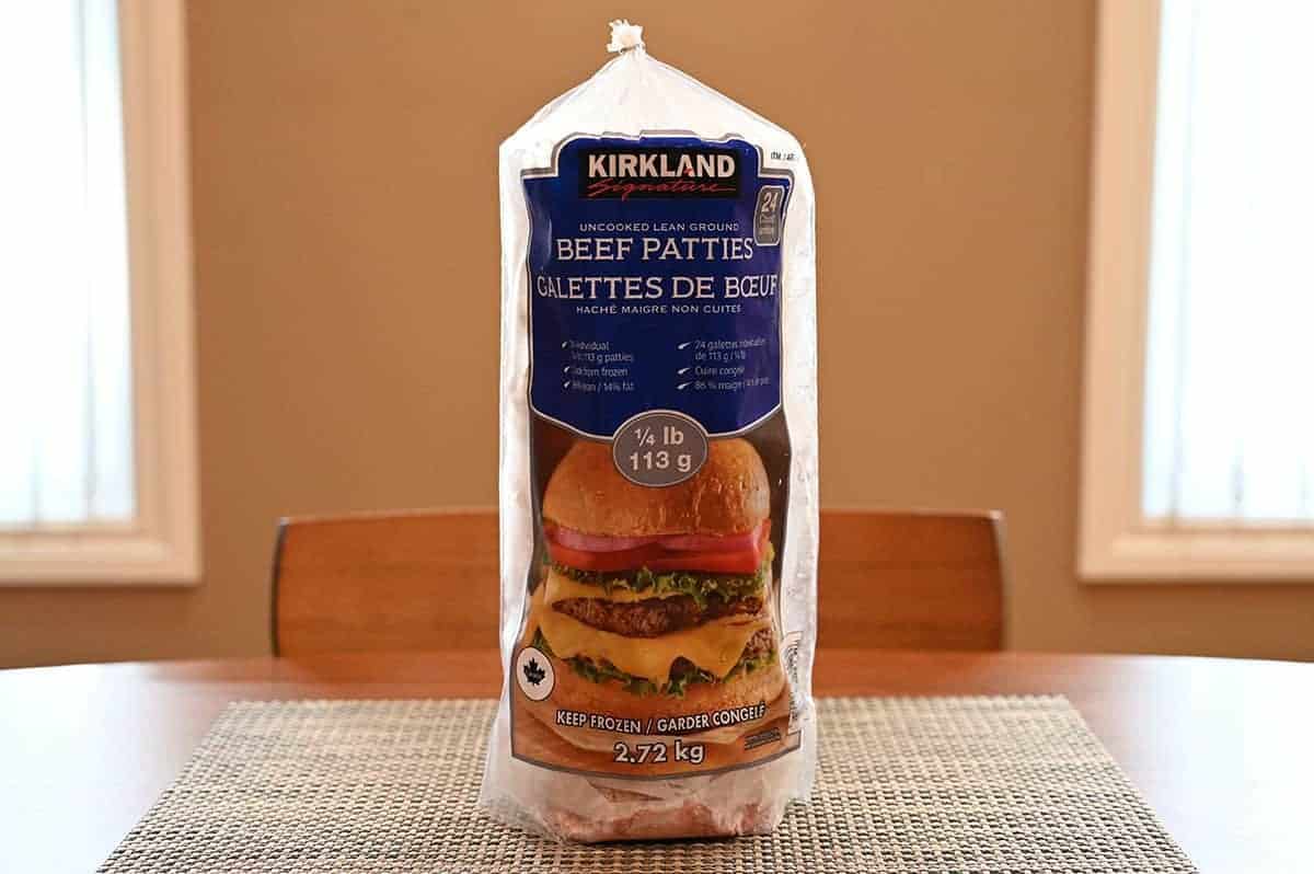 Image of a bag of Kirkland Signature Lean Ground Beef Patties sitting on a table unopened.