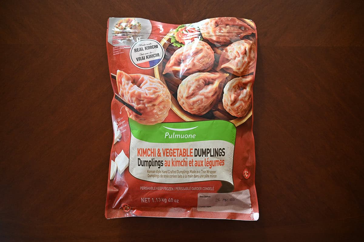 Image of the Costco Pulmuone Kimchi & Vegetable Dumplings bag sitting on a table unopened.