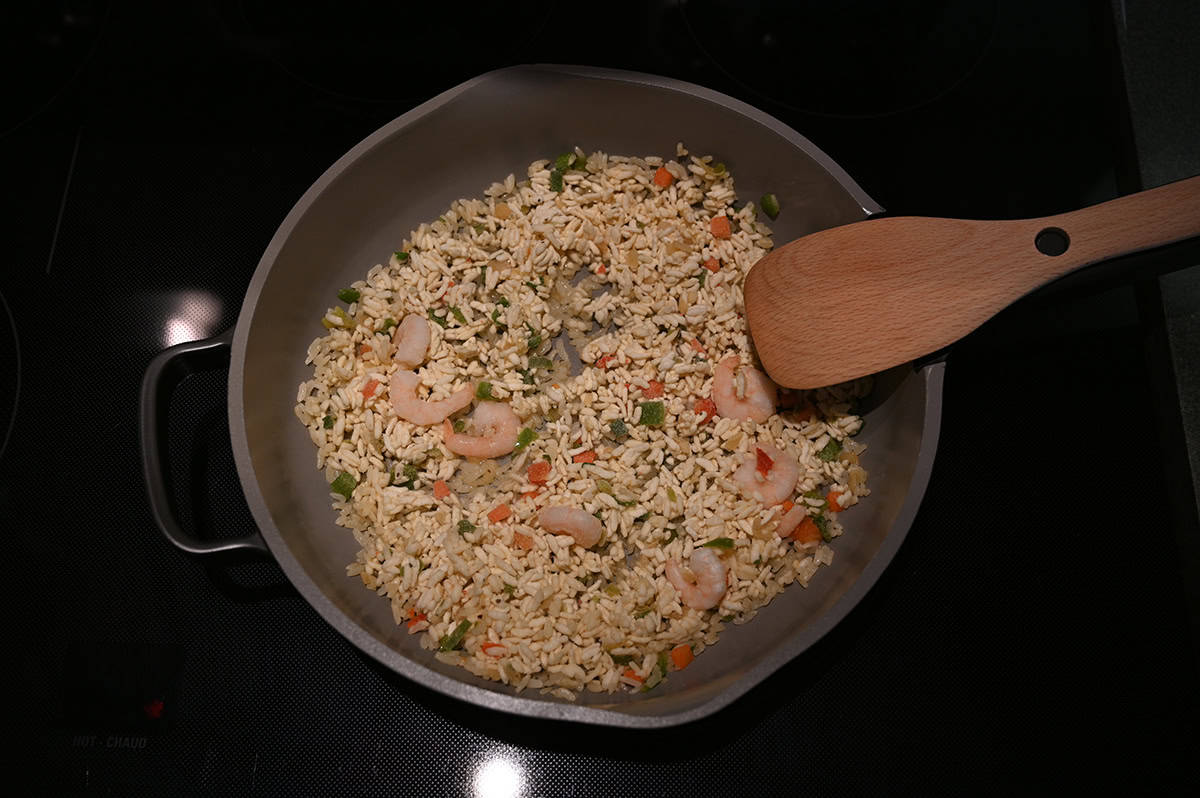 Image of the shrimp fried rice being heated on a frying pan on the stovetop.