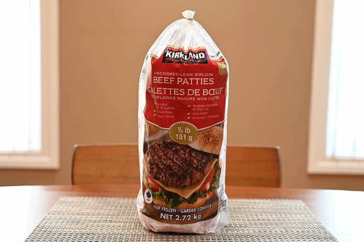 Image of a bag of Kirkland Signature Lean Sirloin Beef Patties sitting on a table unopened.