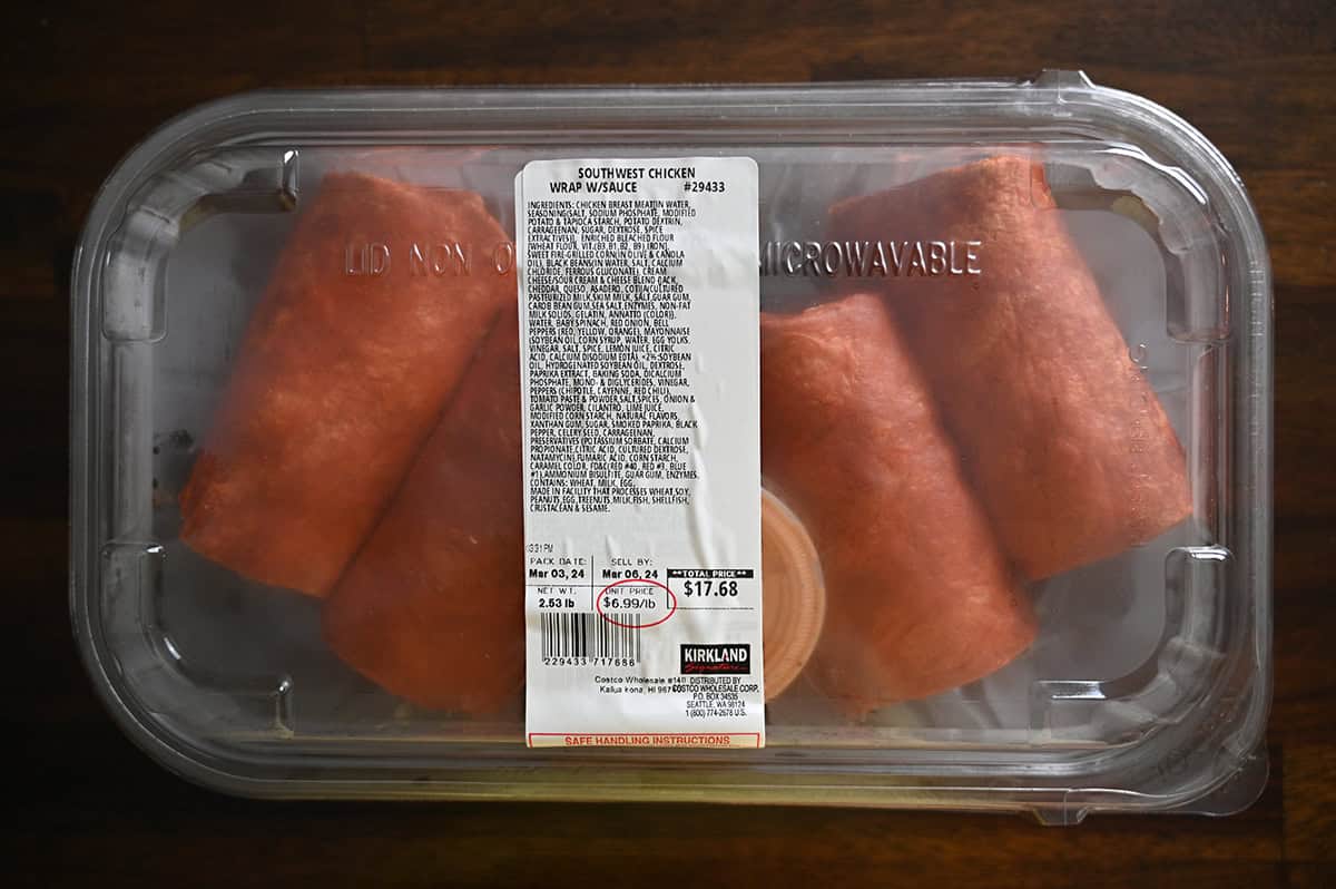 Image of the Costco Kirkland Signature Southwest Chicken Wrap with Sauce container unopened and sitting on a table.