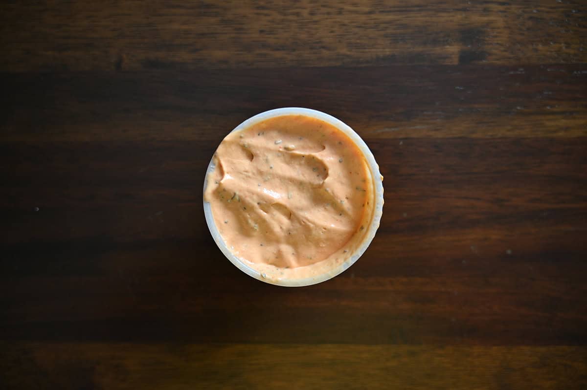 Closeup top down image of a small round container of sauce for the wraps.