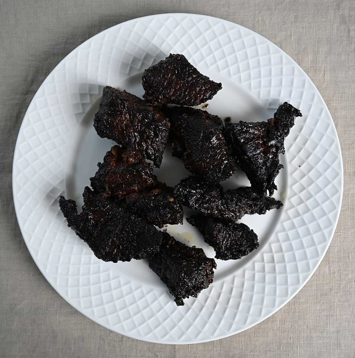 Top down image of a plate of cooked brisket burnt ends. 