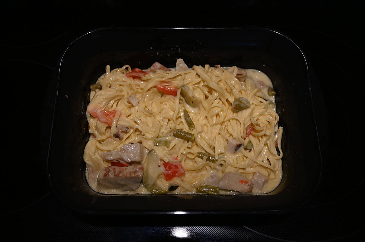 Top down image of the container of pasta after microwaving it and stirring it all together. 