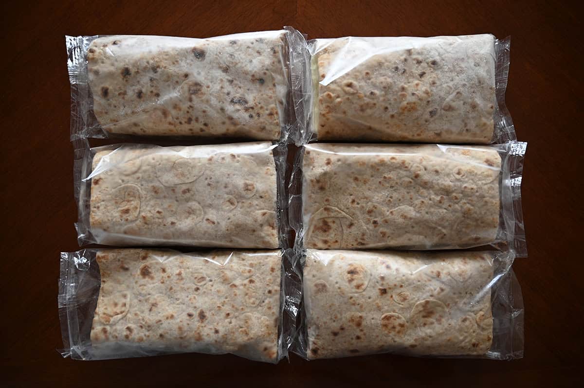 Image of six individually packaged breakfast wraps sitting on a table unopened.