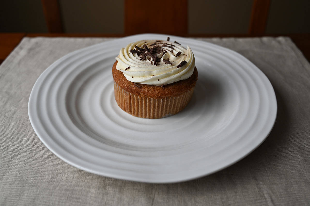 Image of one cinnamon roll mini cake served on a white plate.