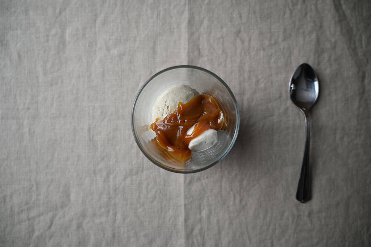 Image of vanilla ice cream with salted caramel drizzled on top.