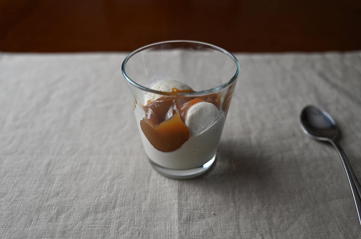 Image of a small glass dish with vanilla ice cream and salted caramel in it.