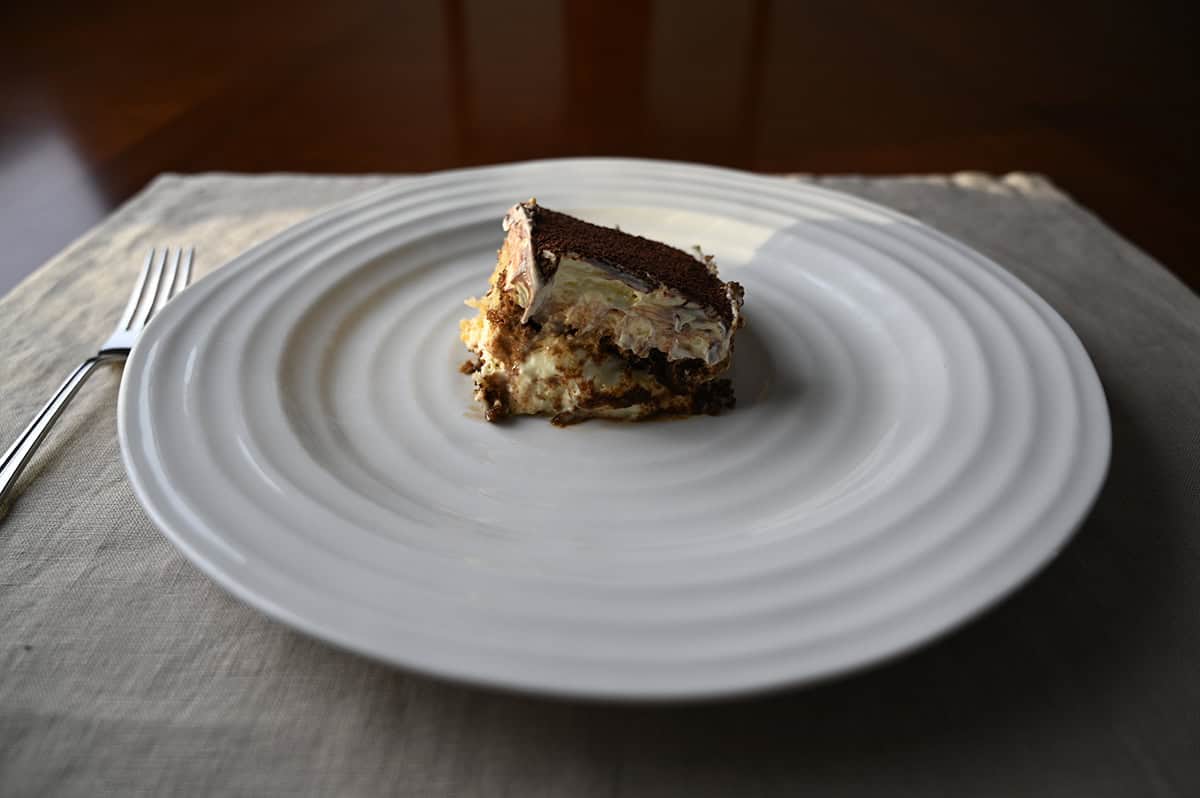 Image of one slice of Tiramisu Scoop Cake served on a white plate.