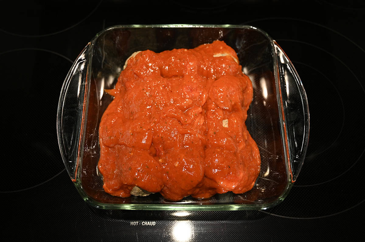 Image of meatballs in a baking dish covered in tomato sauce.