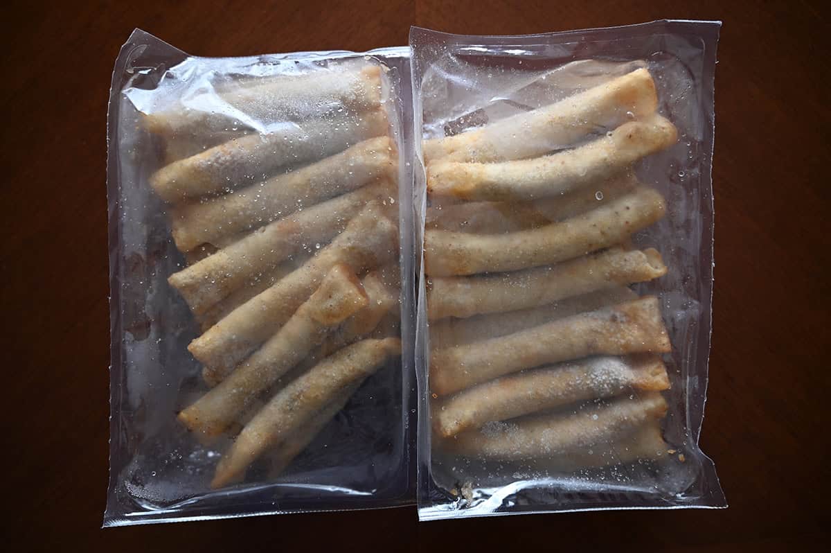 Image of two sealed plastic packages with tacos in them sitting on a table. 