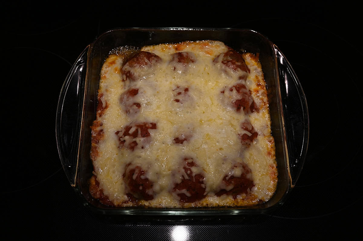 Image of dish with a meatball bake in it sitting on a stovetop.