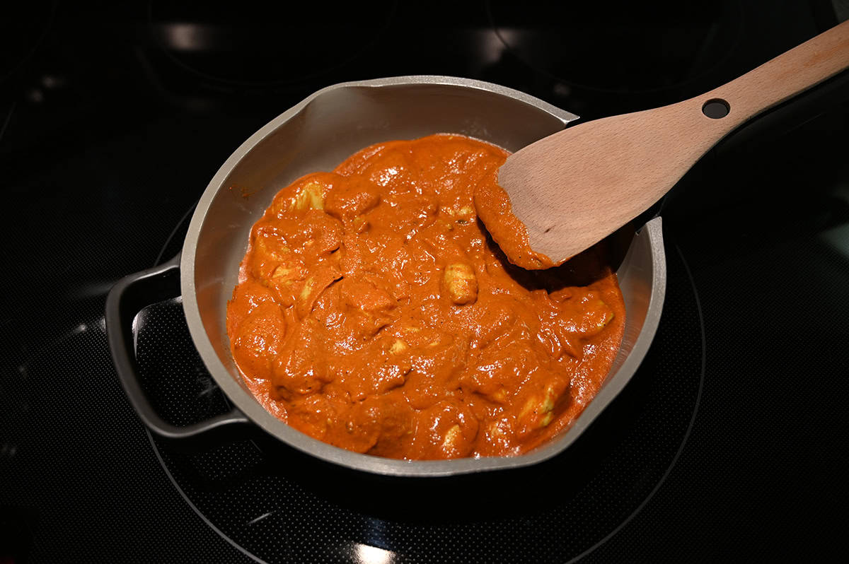 Image of curry being cooked in a saucepan on the stovetop.