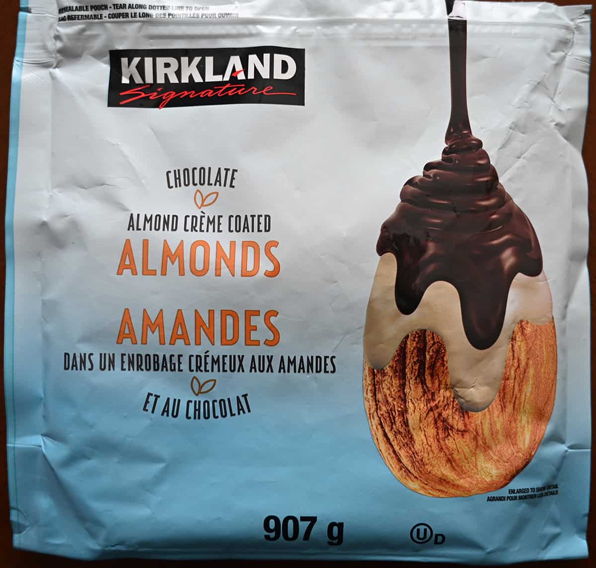 Close up image of the front of the Costco Kirkland Signature Chocolate Almond Creme Coated Almonds bag. 