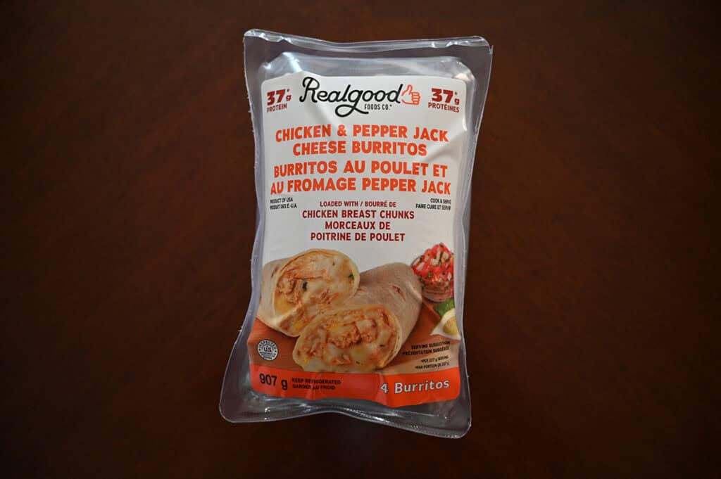 Packaged of the Costco Realgood Foods Chicken & Pepper Jack Cheese Burritos sitting on a table unopened.